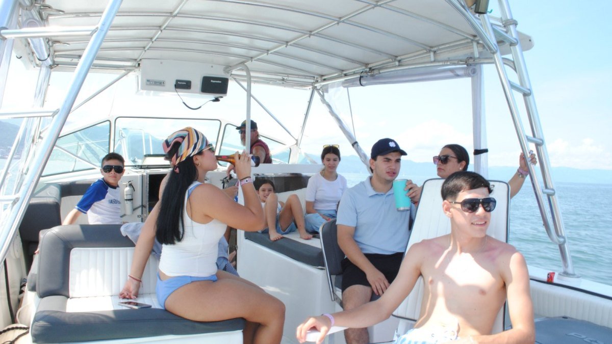 Guests relaxing under the shade canopy of a private charter boat in Banderas Bay, Nuevo Vallarta