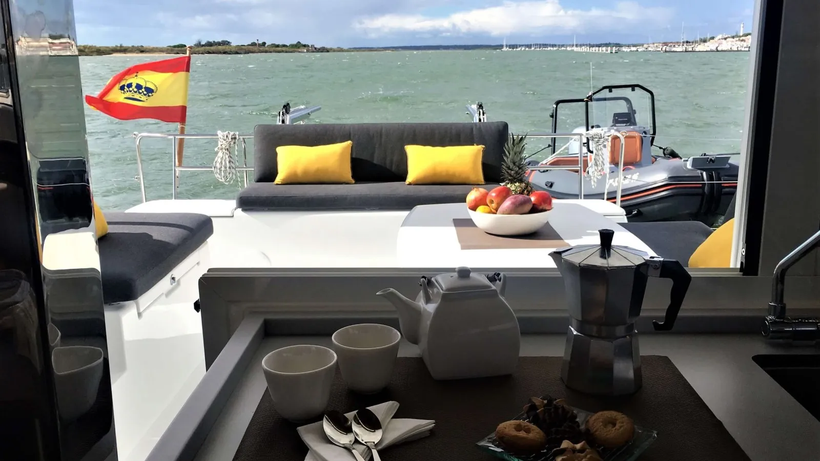 Shaded deck of a private catamaran rental in Puerto Vallarta set for breakfast before a south shore yacht day